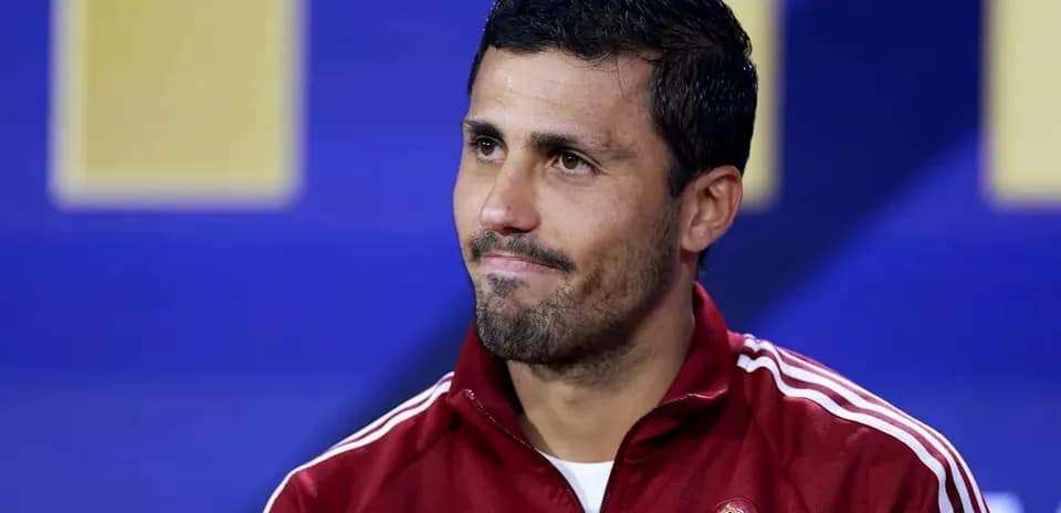 Player wearing Spain training jacket at press conference