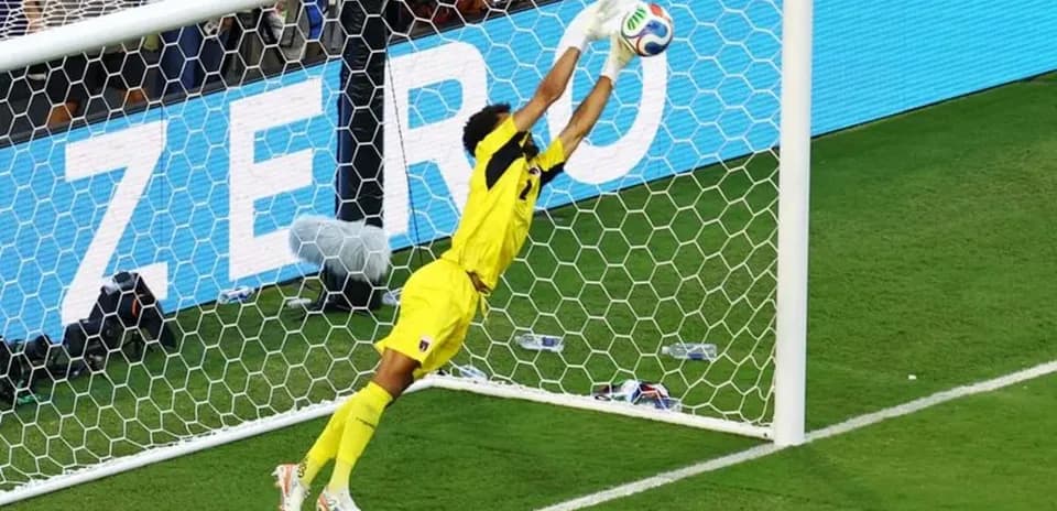 Goalkeeper diving to save a shot on goal