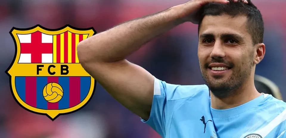 Player smiling with Manchester City and Barcelona logos