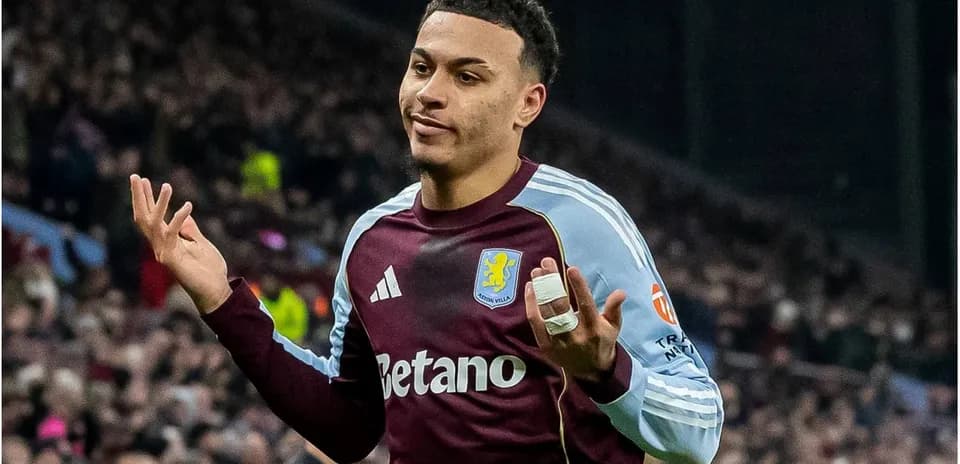 Player gesturing during match, wearing Aston Villa kit
