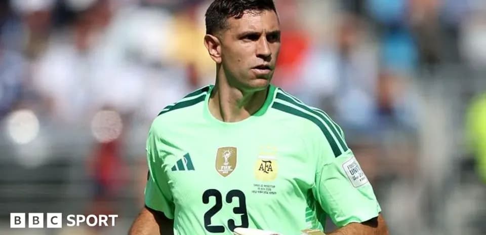 Goalkeeper in green kit preparing for match