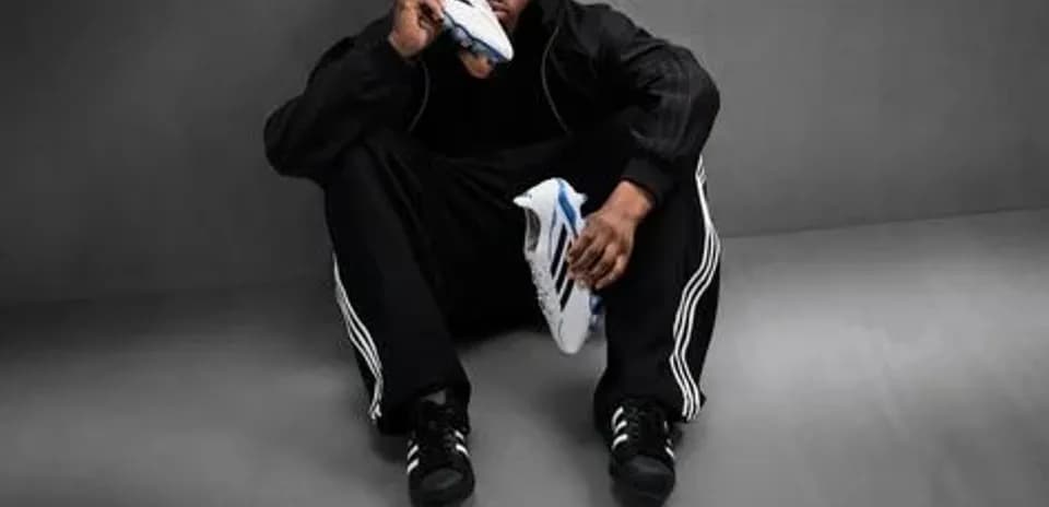 Athlete sitting with soccer shoes in hand