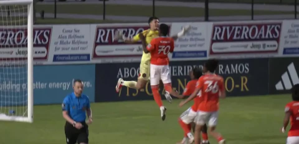 Goalkeeper catching the ball during match action
