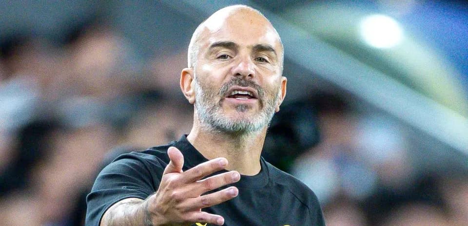Coach gesturing during a football match