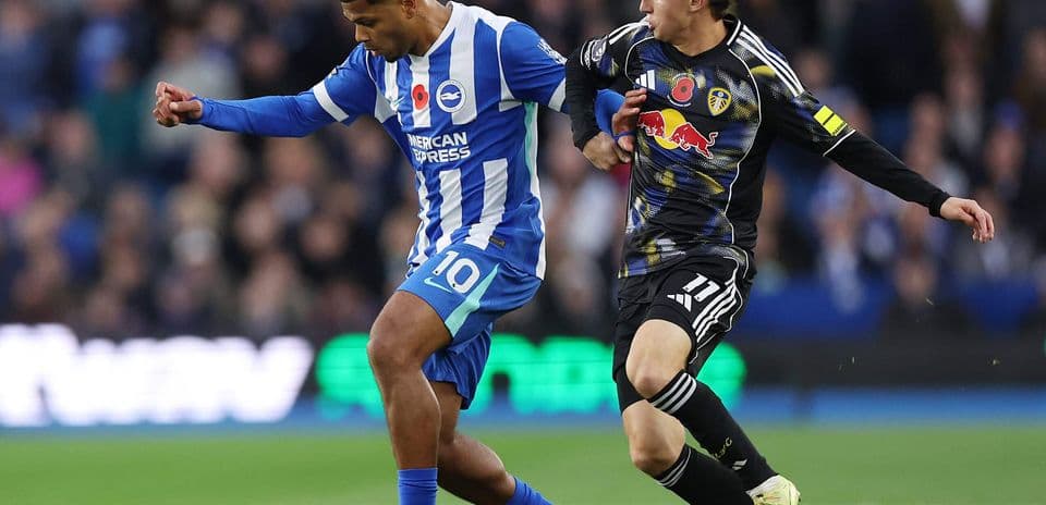 Brighton player dribbling past Leeds defender