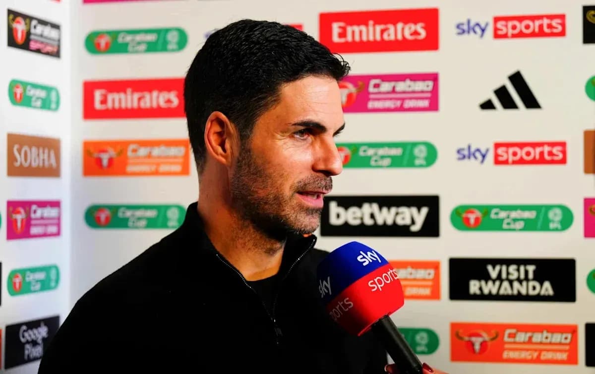 Manager speaking during a press conference with microphones