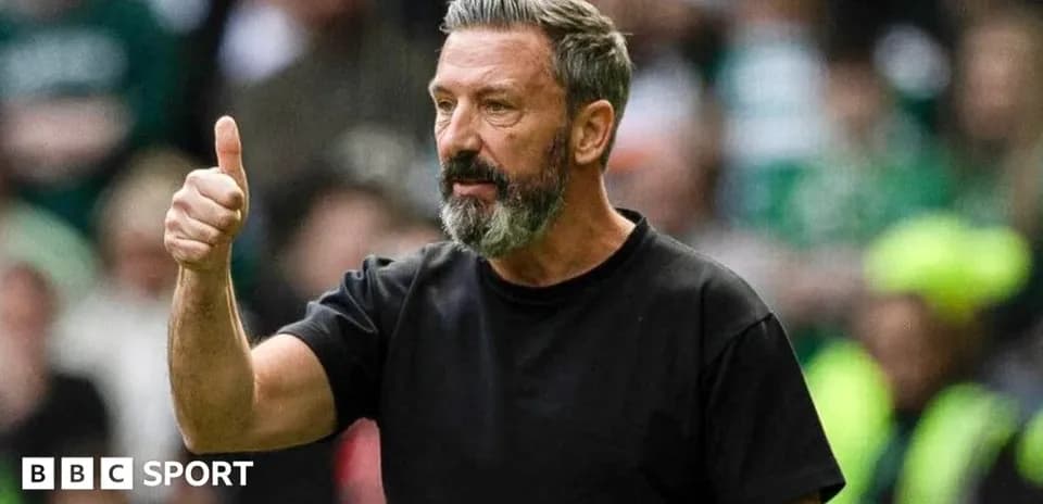 Manager giving thumbs up during match action