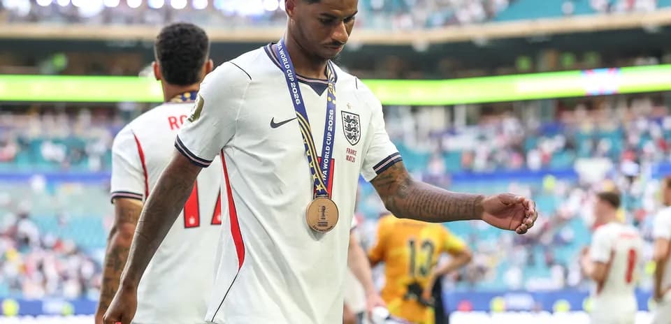 Player walking off field with medal after match