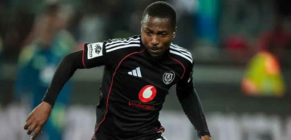 Player sprinting in black kit during match