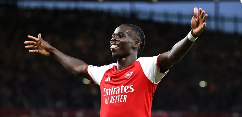 Arsenal player celebrating a goal with arms raised
