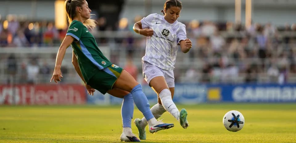Players competing for the ball during NWSL match