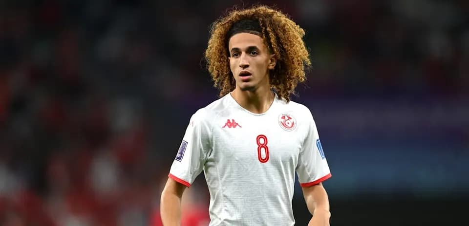 Player wearing Tunisia jersey during match on field