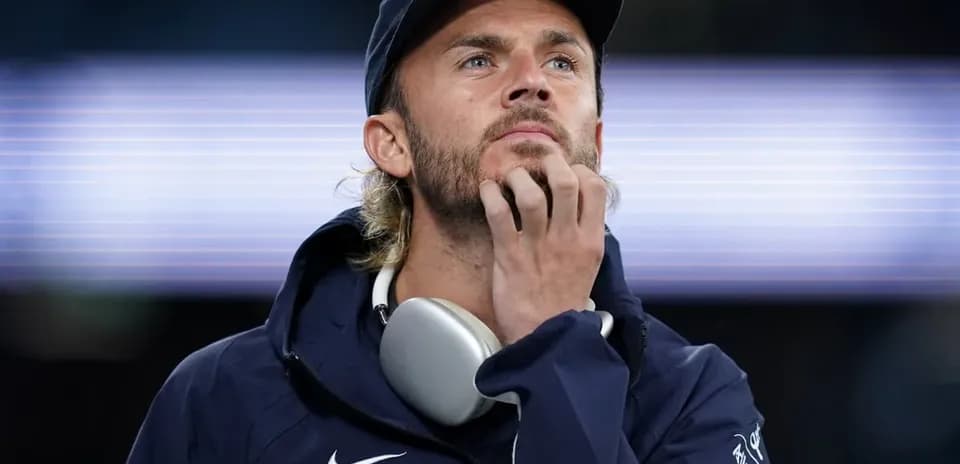 Man wearing headphones, deep in thought