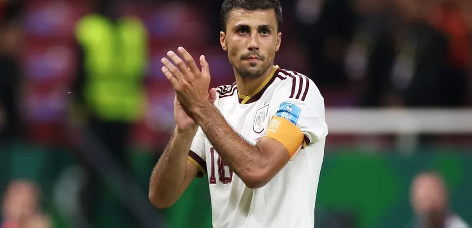 Player applauding fans after match wearing captain's armband