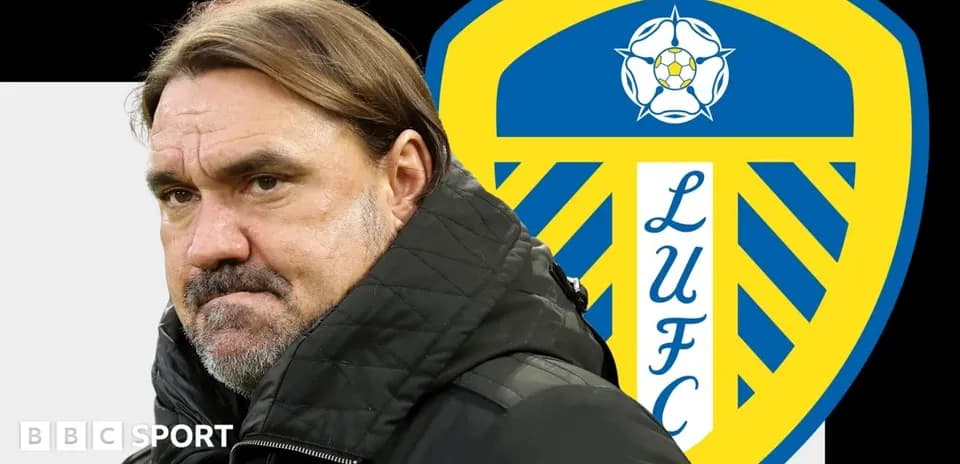 Coach standing in front of Leeds United logo