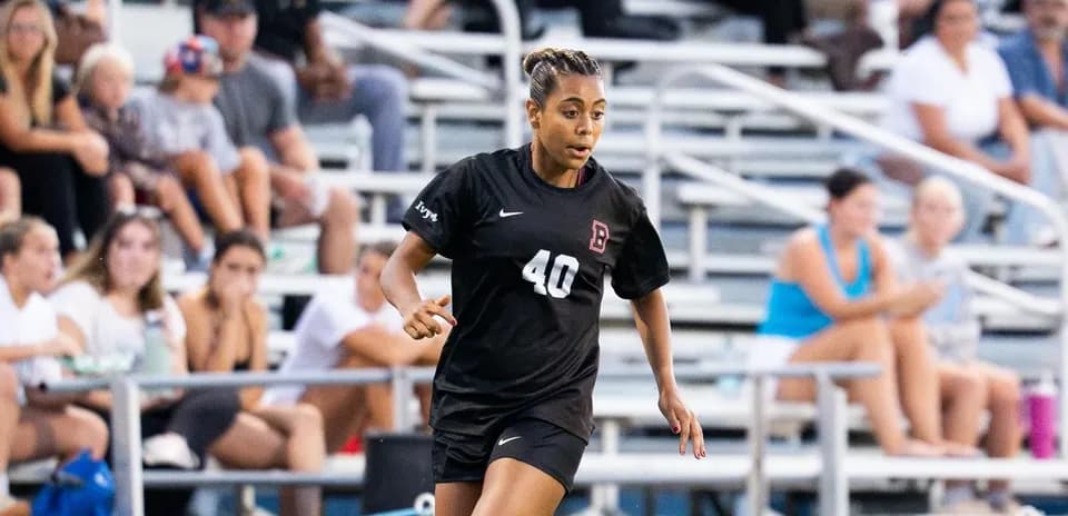 Player wearing black jersey running on the field