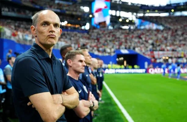 Coach observing match from the sidelines with team