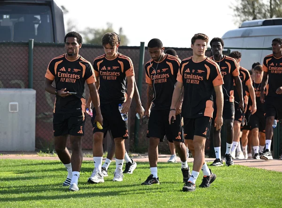Arsenal players walking together in training kits