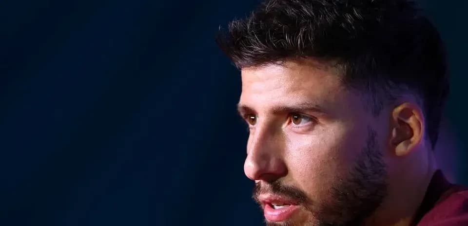 Player speaking at press conference with microphone