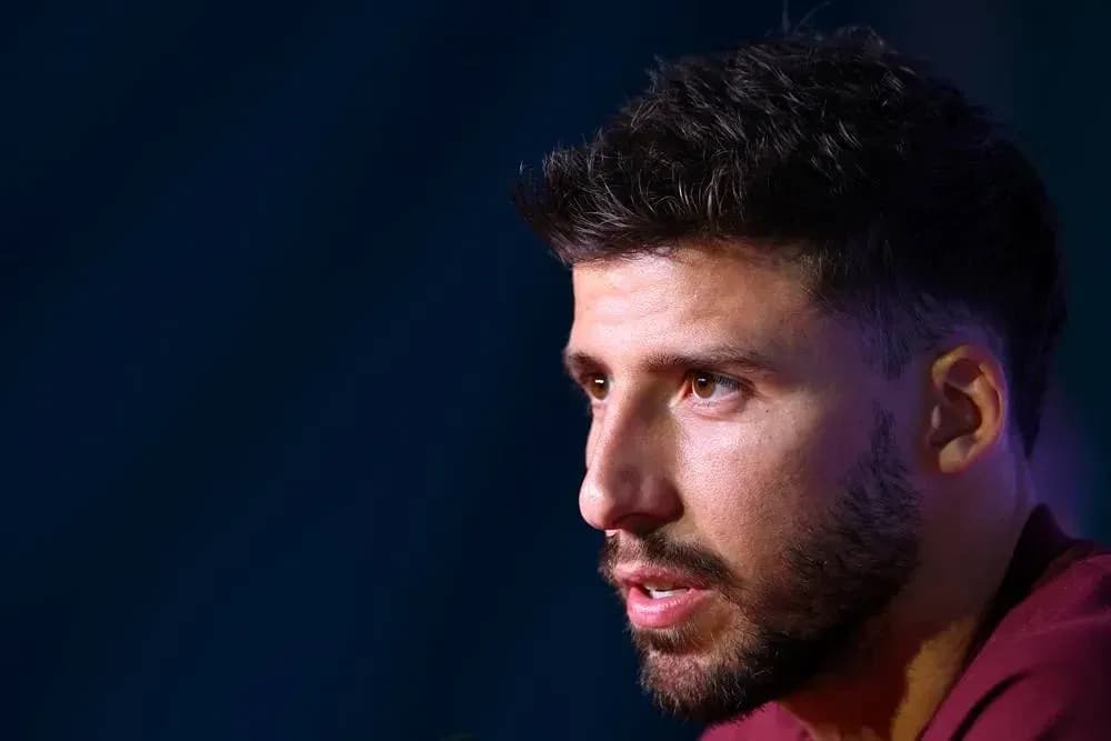 Player speaking at press conference with microphone