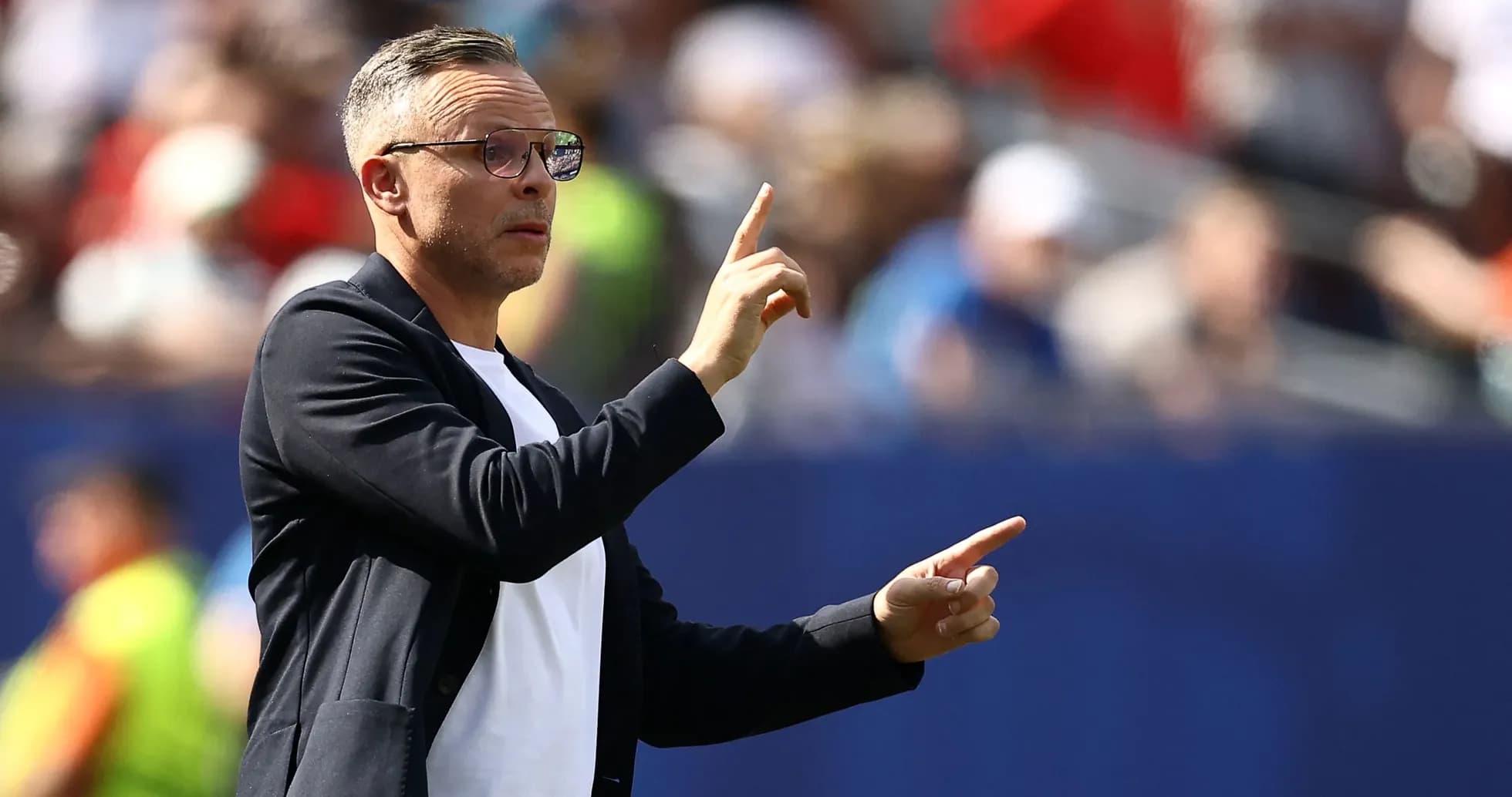 Coach gesturing from the sidelines during match