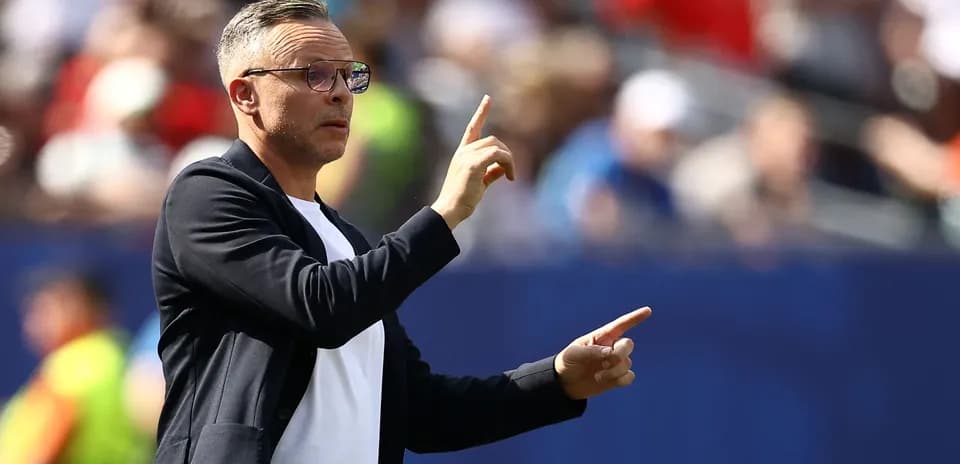Coach gesturing from the sidelines during match