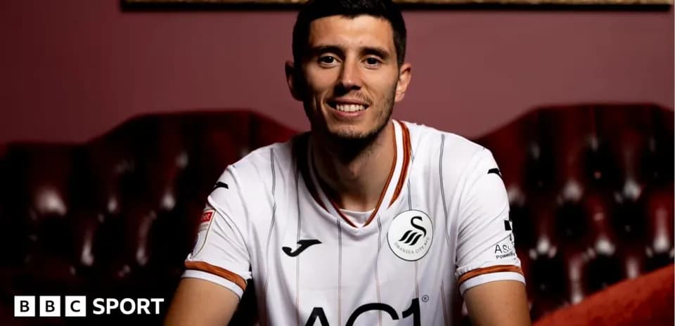Player in Swansea City jersey smiling for photo