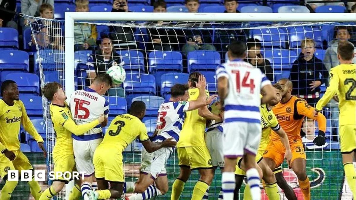 Players contesting a header in front of the goal