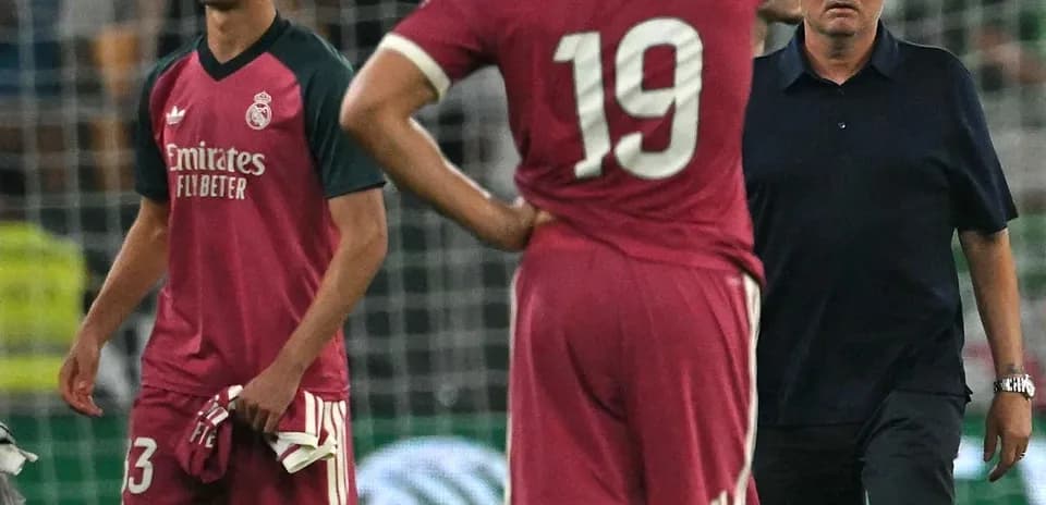 Players and coach discussing on the field after match