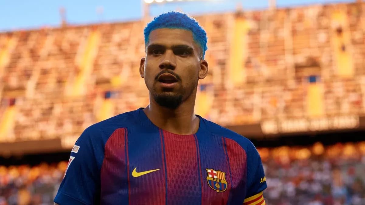 Player with blue hair in Barcelona jersey on field
