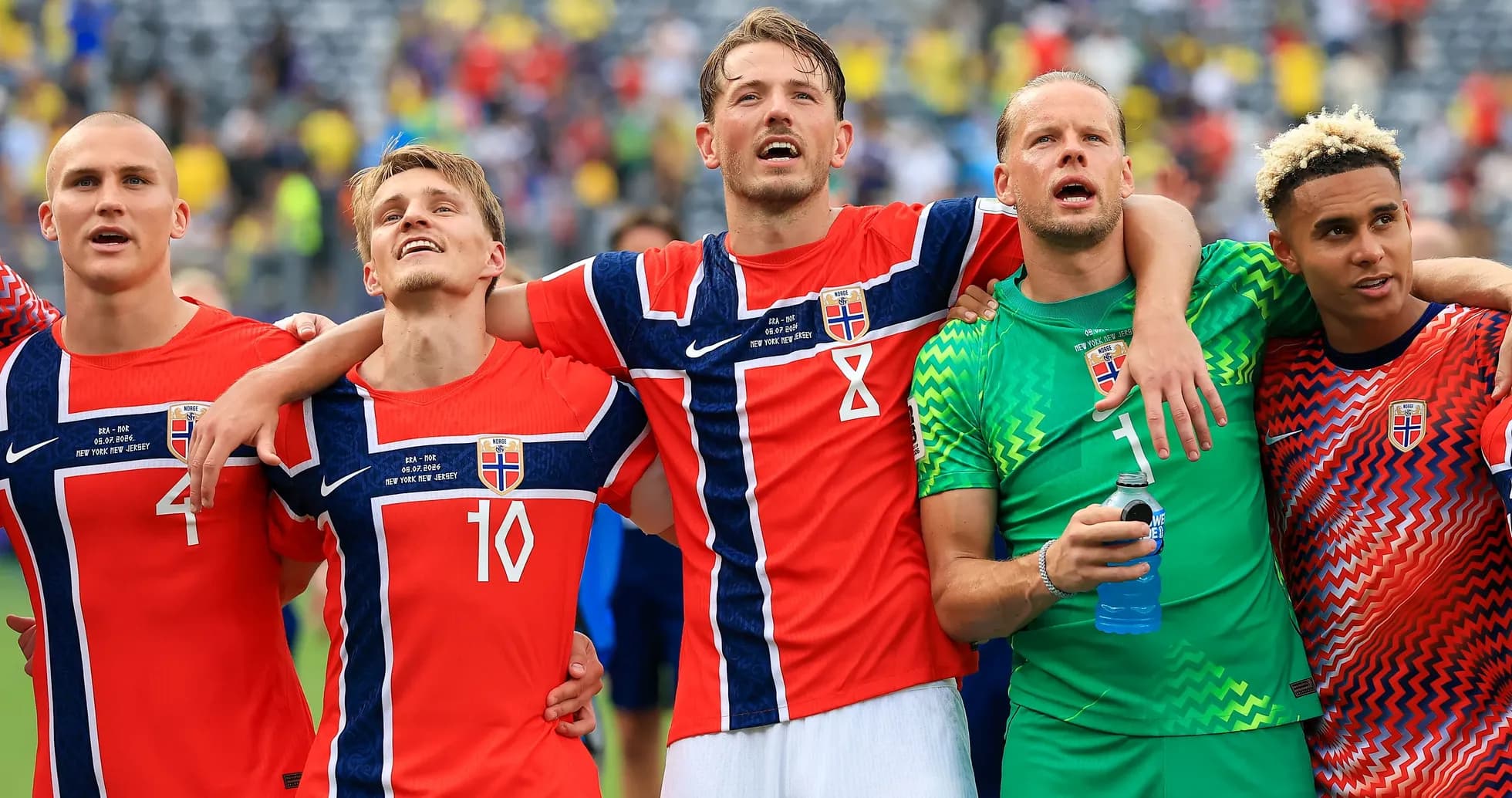 Norwegian football players celebrating together after match