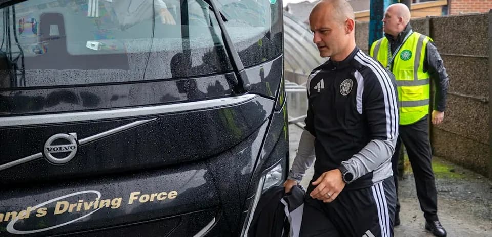 Team members boarding bus in rainy weather