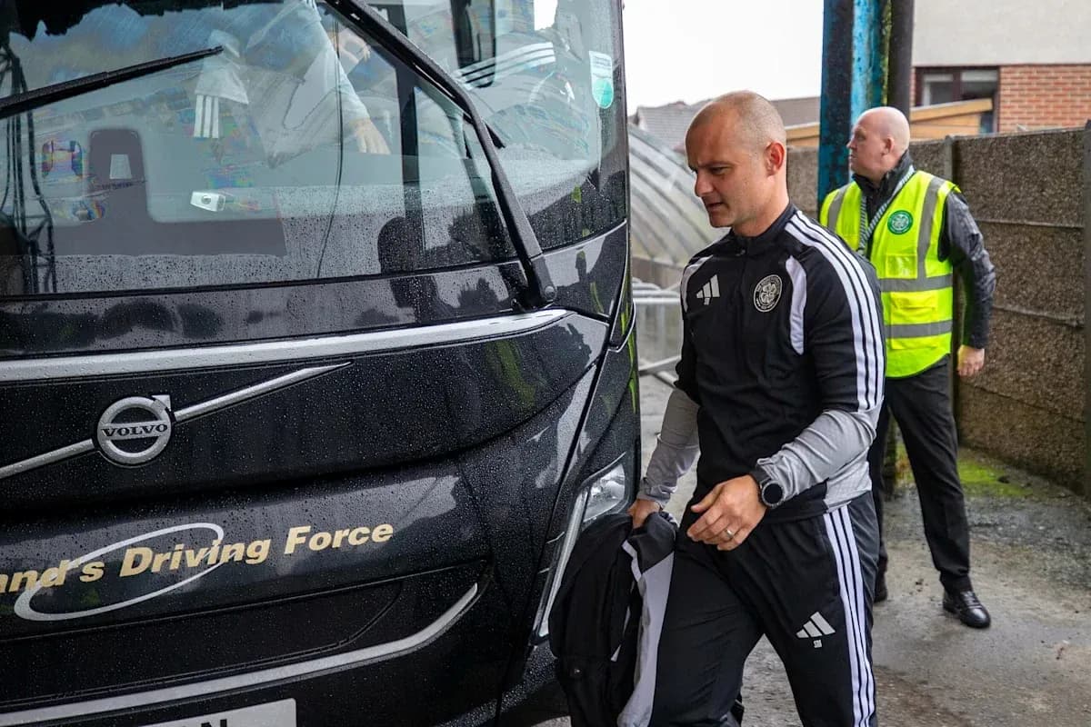 Team members boarding bus in rainy weather