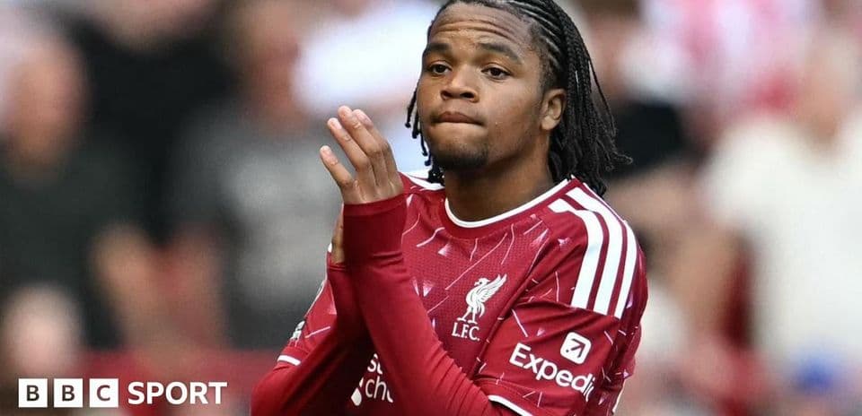 Player in Liverpool kit applauding the crowd