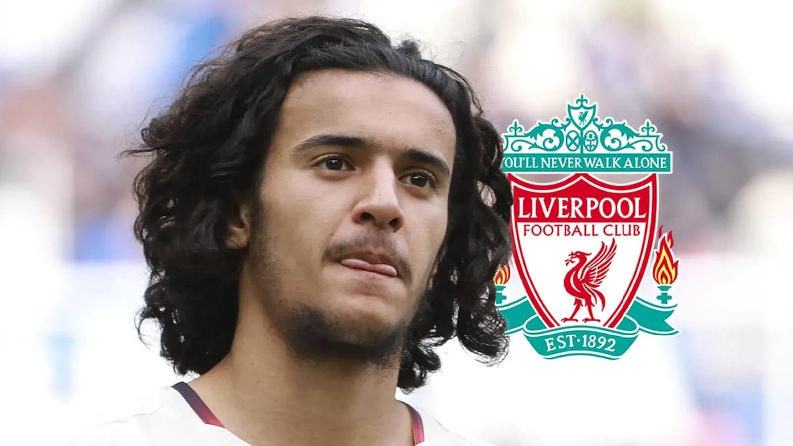 Player with curly hair and Liverpool FC logo