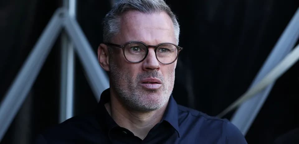 Man with glasses looking thoughtfully outdoors