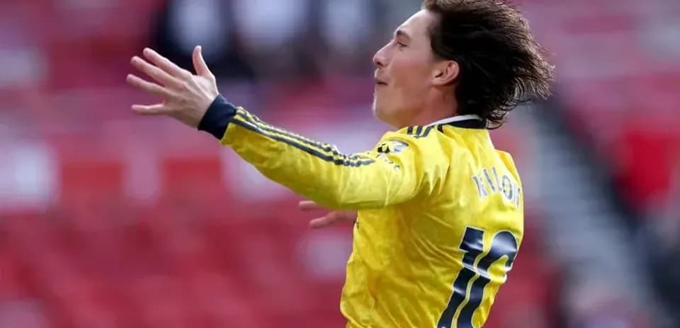 Player celebrating in yellow jersey on pitch