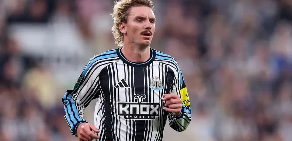 Player running in Newcastle United home jersey