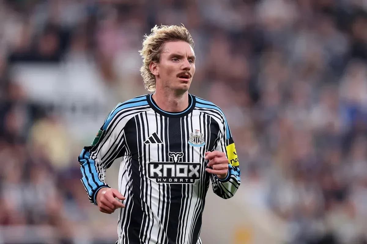 Player running in Newcastle United home jersey