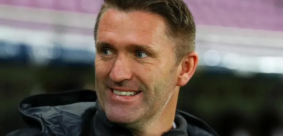 Coach smiling during a match warm-up session