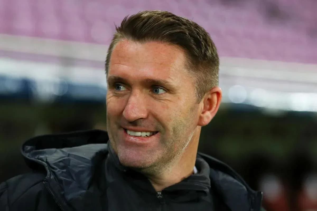 Coach smiling during a match warm-up session