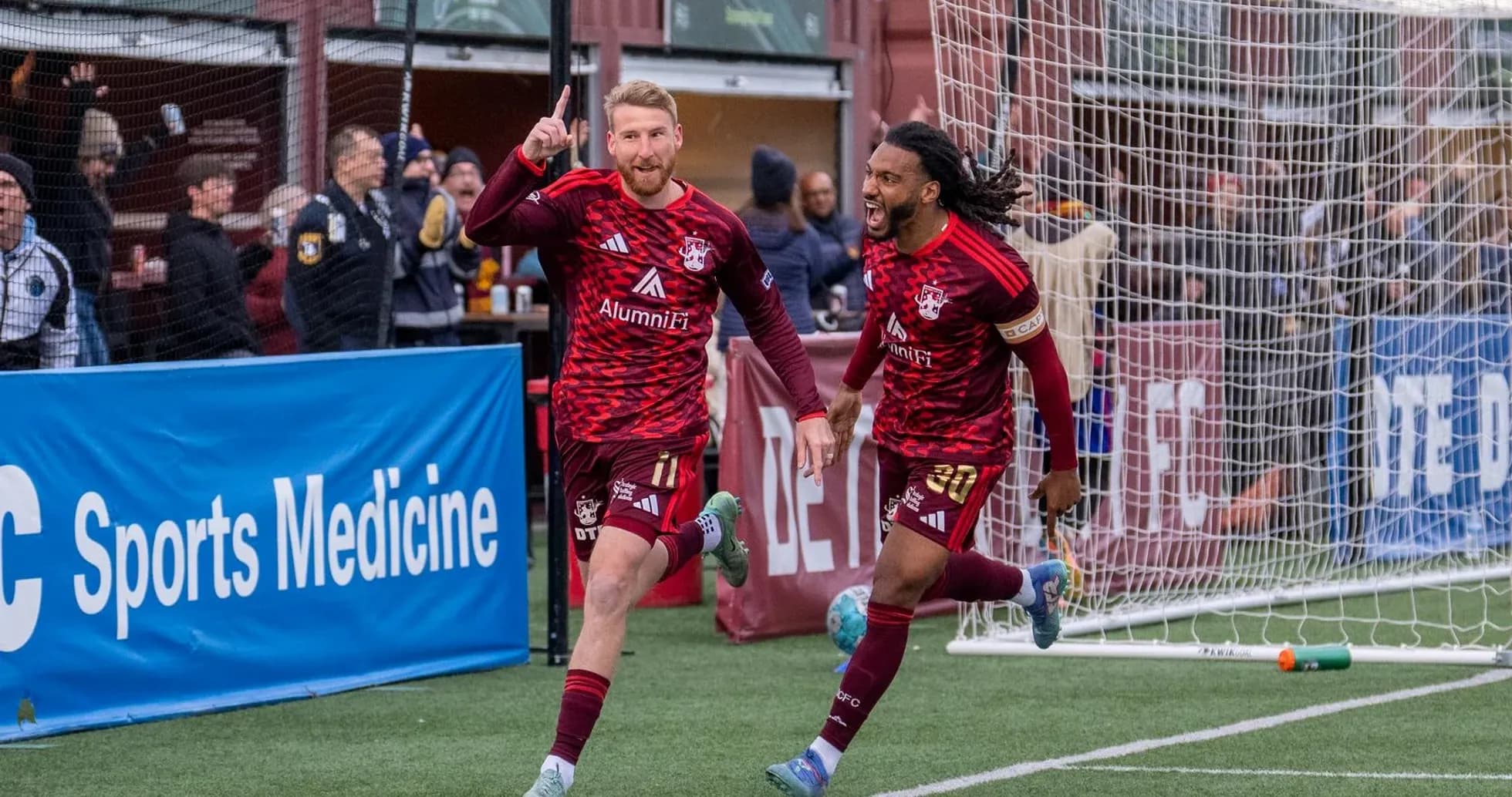 Players celebrating goal during Detroit City match