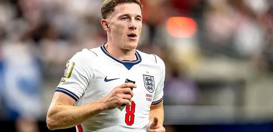 Player wearing England kit running on the field