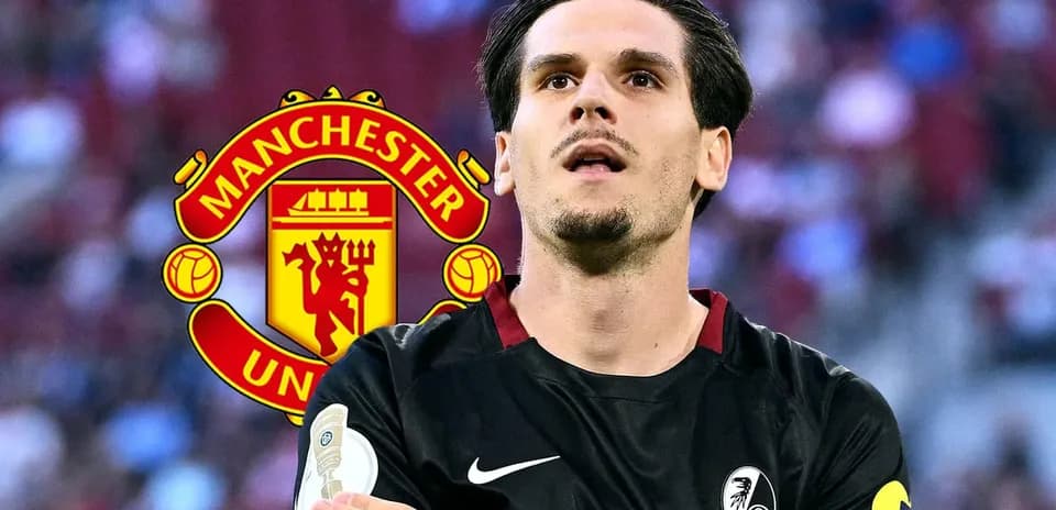 Player in black kit with Manchester United logo backdrop