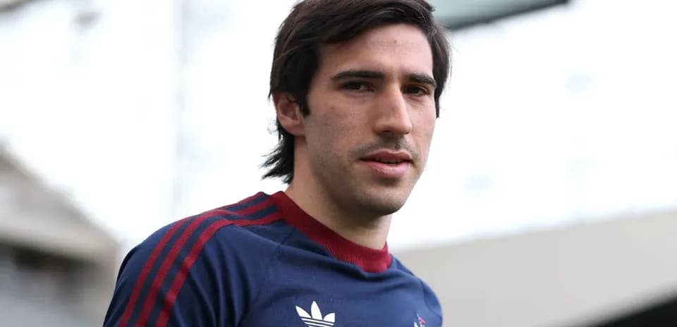 Player posing in training kit at stadium