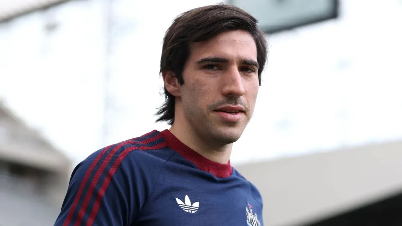 Player posing in training kit at stadium