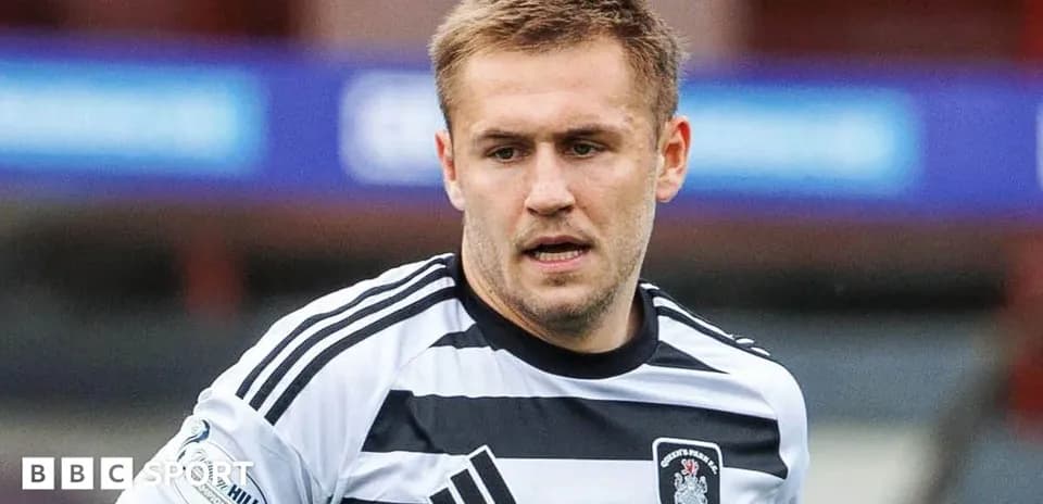 Player wearing black and white striped jersey during match