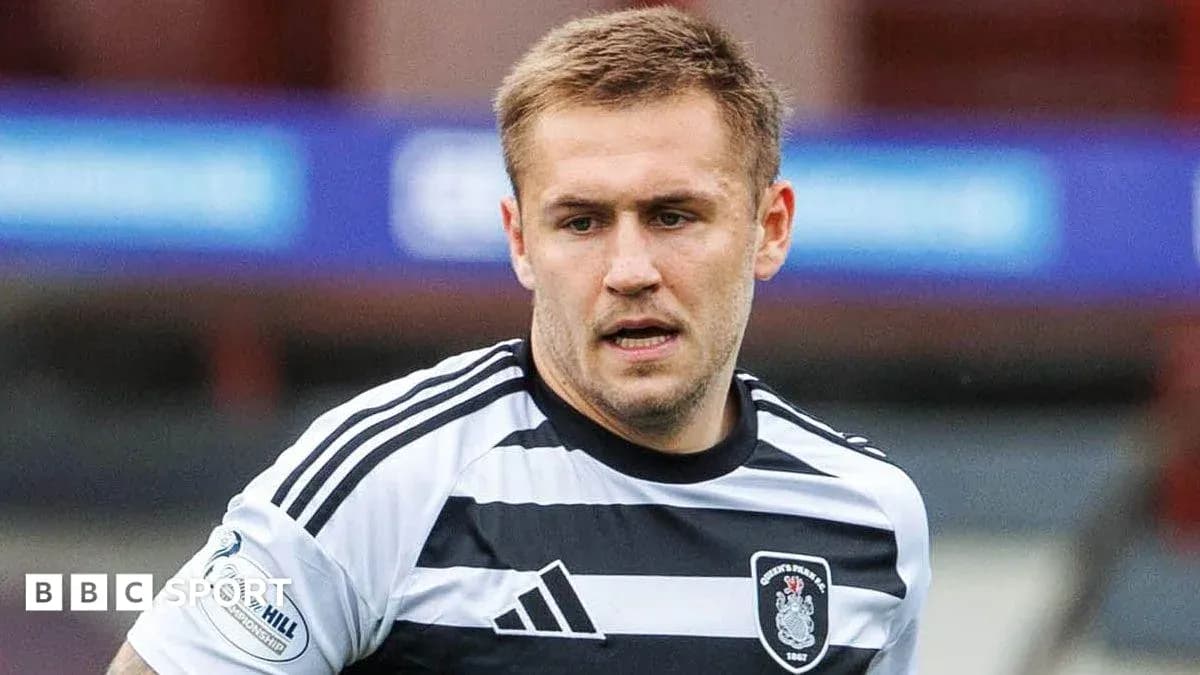 Player wearing black and white striped jersey during match