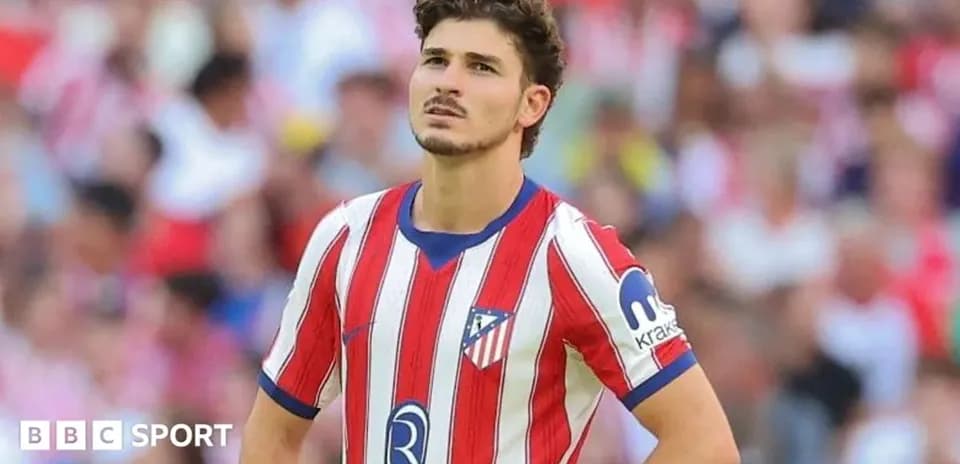 Atletico Madrid player during match with fans in background