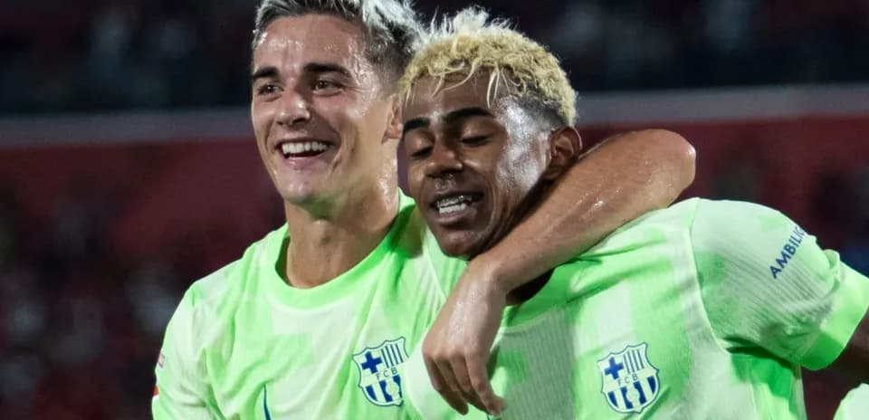 Two players celebrating together after scoring a goal